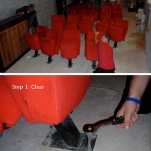 Volunteers removing cinema seats